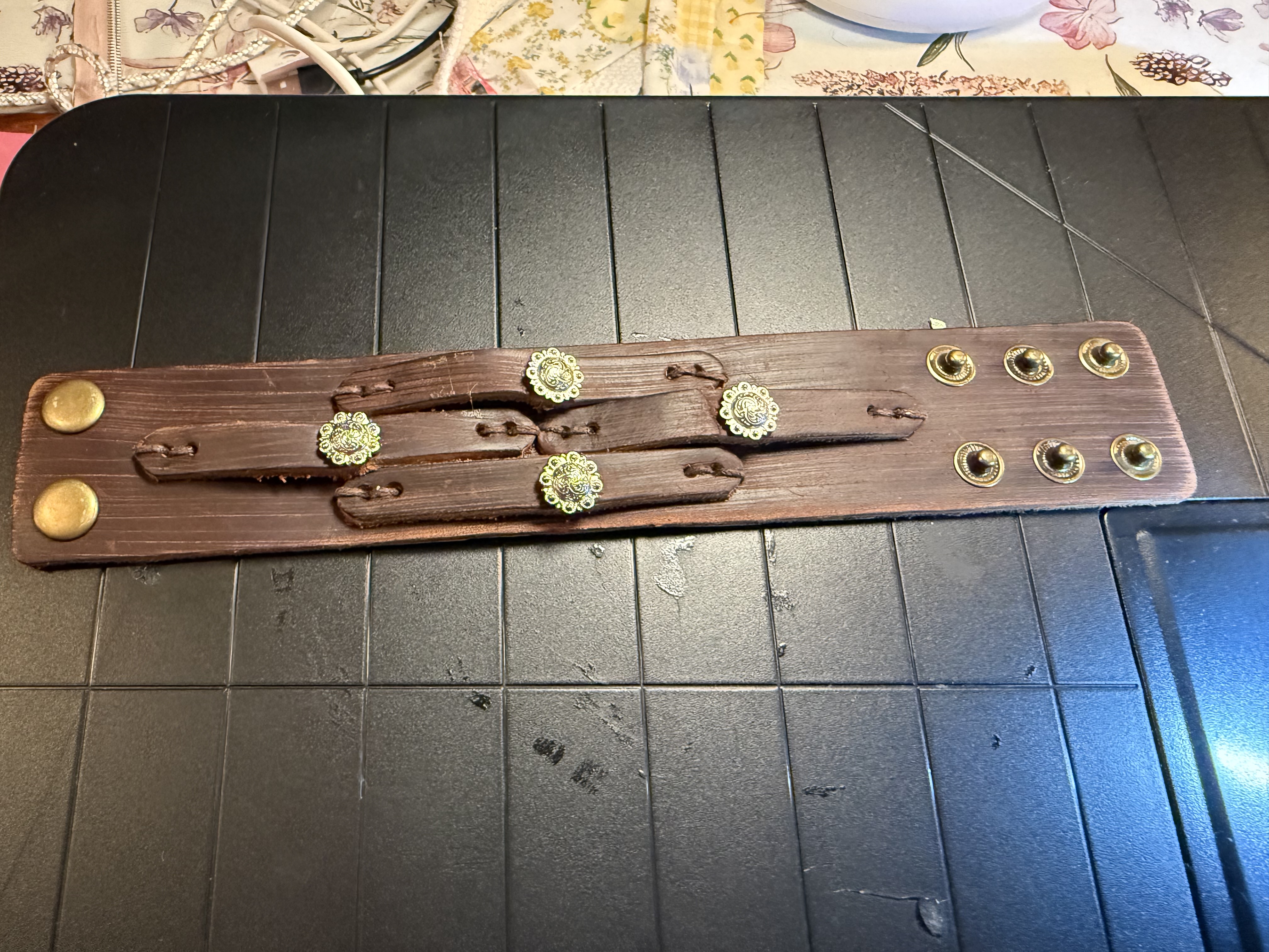 Dark leather cuff with floral conchos