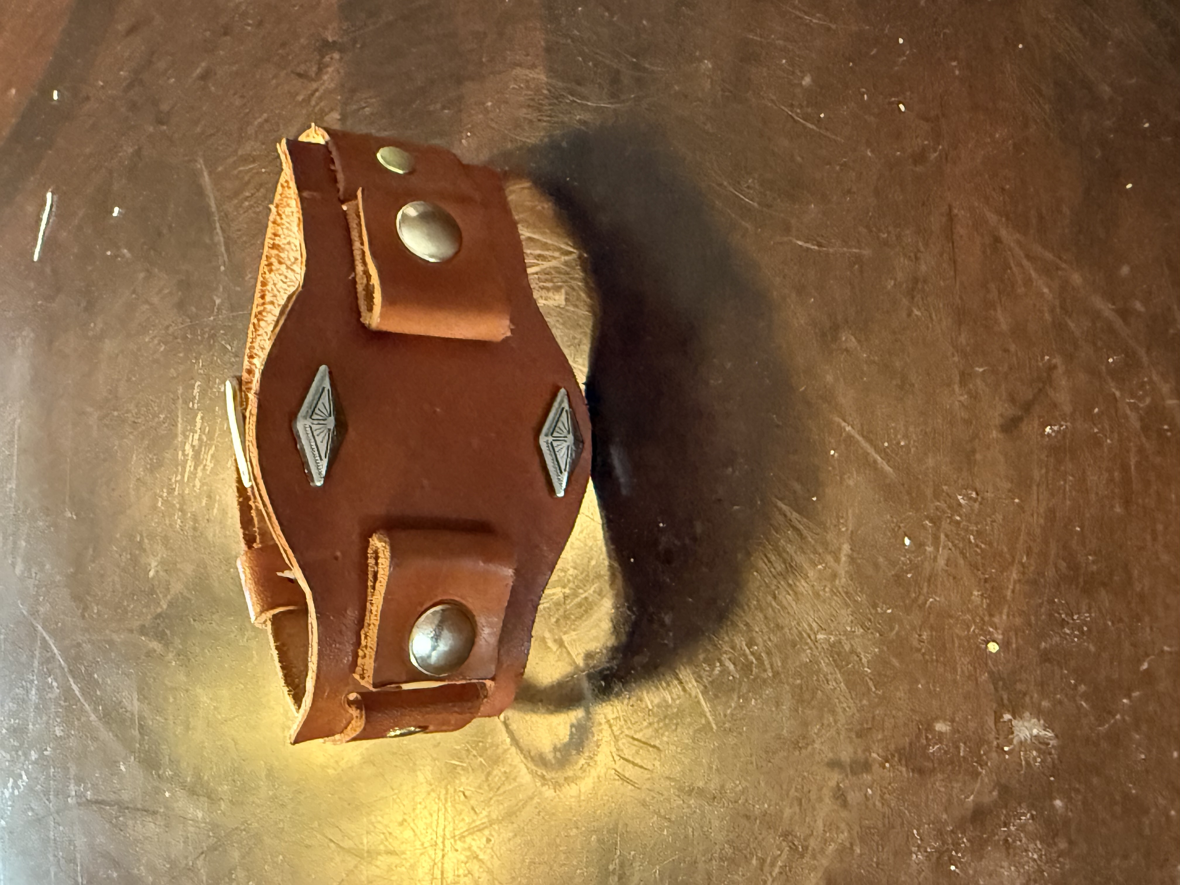 Tan leather cuff with turquoise stones and silver concho